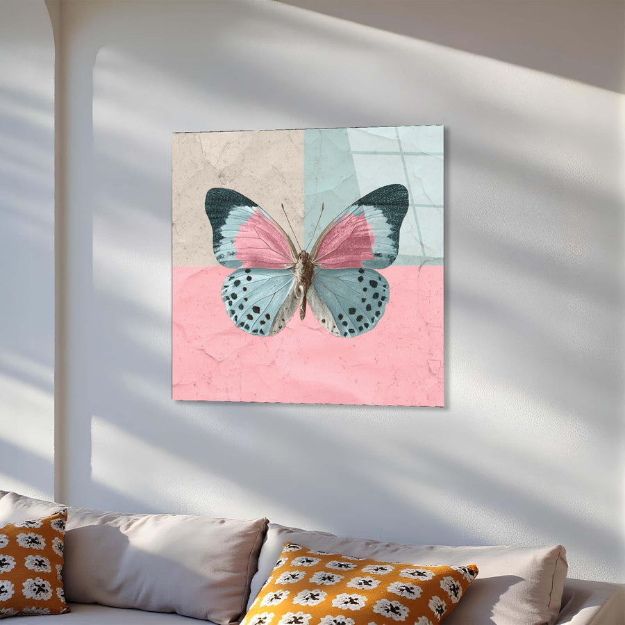 Butterfly artwork on a wall above a sofa with decorative pillows.