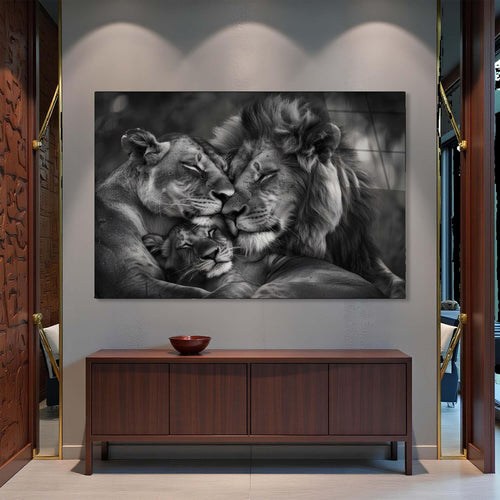 Black and white photo of a lion family with a lioness, male, and cub.
