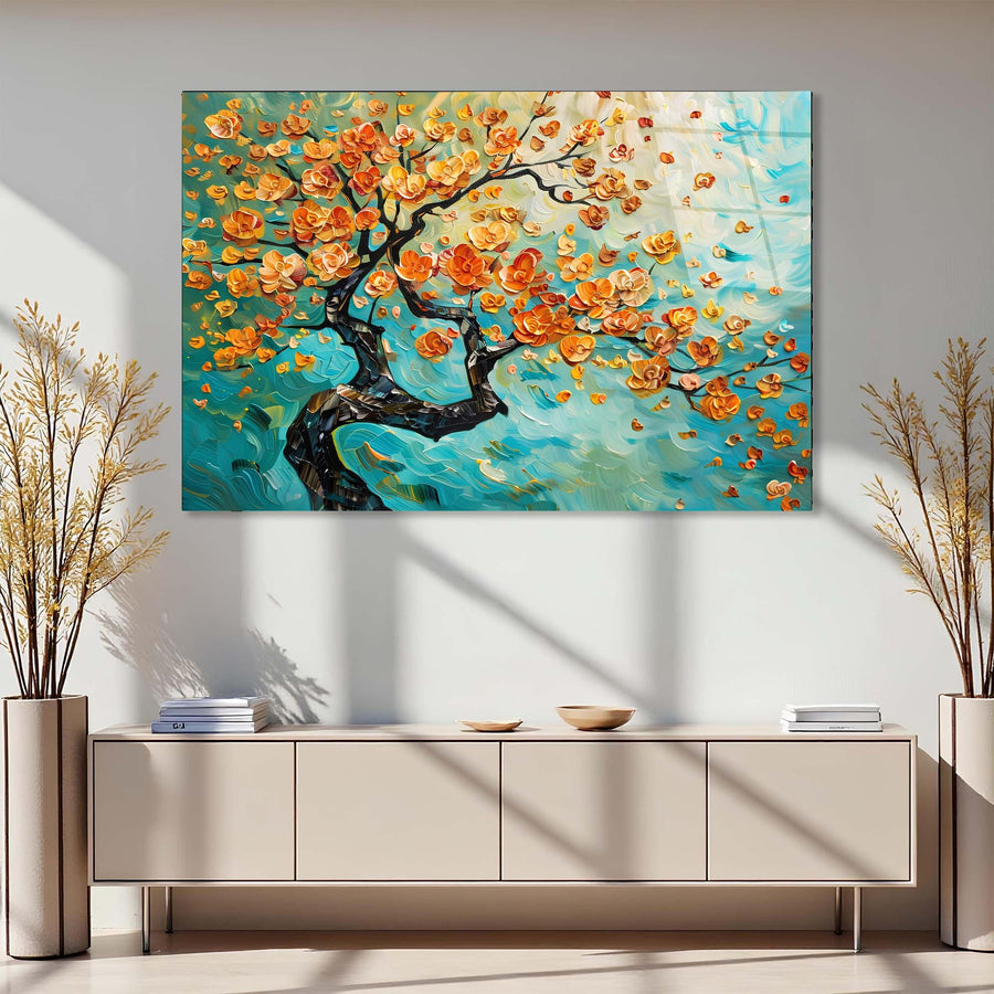 Colorful abstract painting of a tree with orange flowers on a wall above a light-colored cabinet.