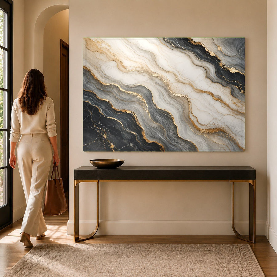 The abstract Marble Flow tempered glass print hanging in a luxurious hotel lobby behind the reception desk.