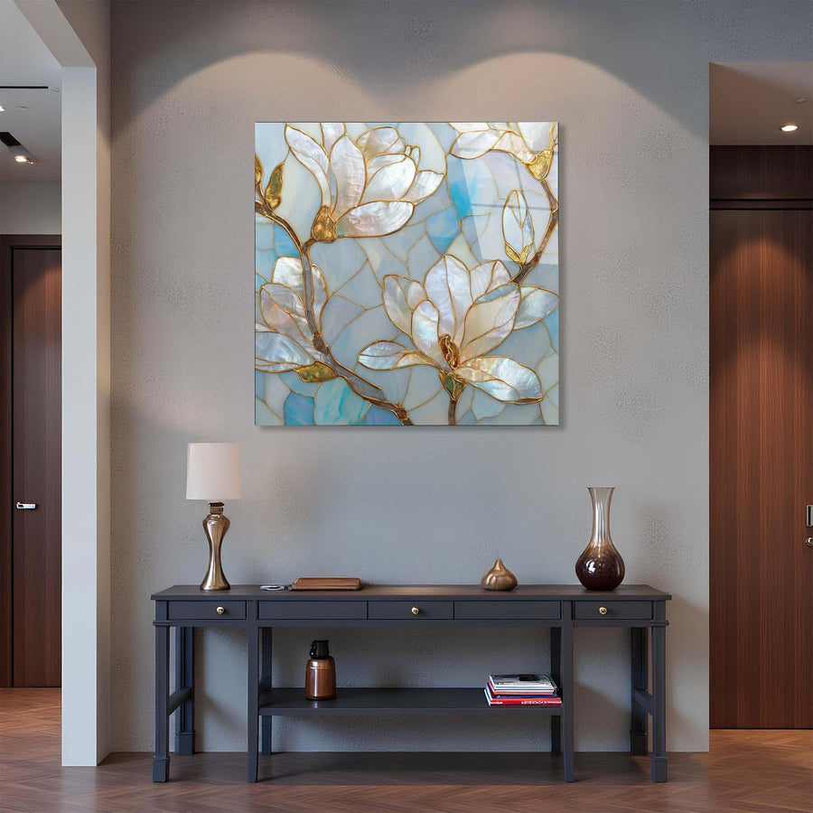 Decorative floral painting on a wall above a console table with a lamp and vases.