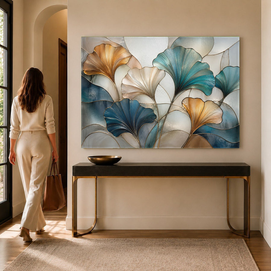 Close-up of the glossy surface on the blue botanical glass print hanging in a bright, sunlit hallway.