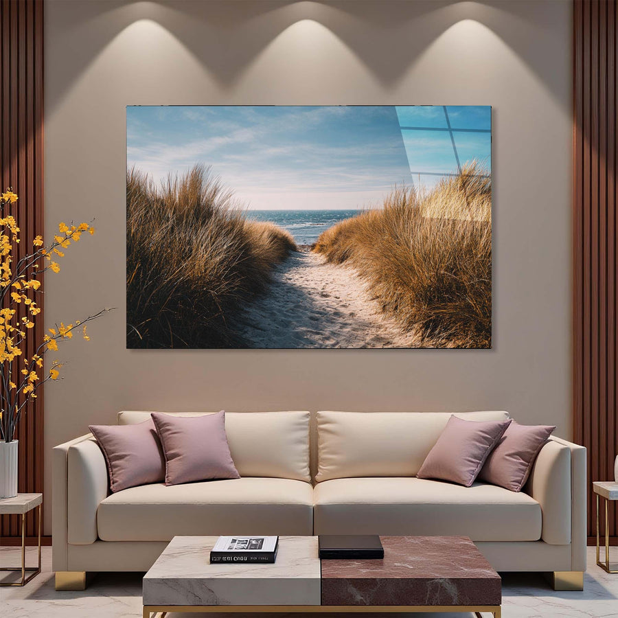 Modern living room with a large TV displaying a beach scene, beige sofa, and decorative elements.