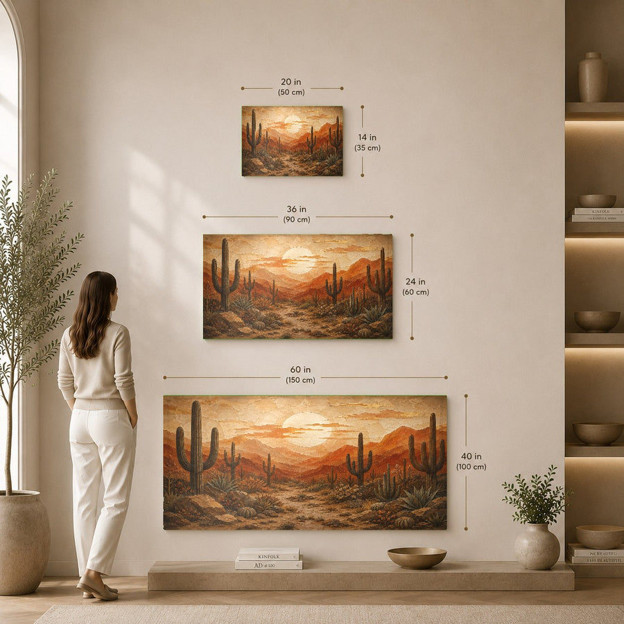 Angled view of a frameless desert sunset glass art piece mounted on a textured plaster wall in an artistic dining room.