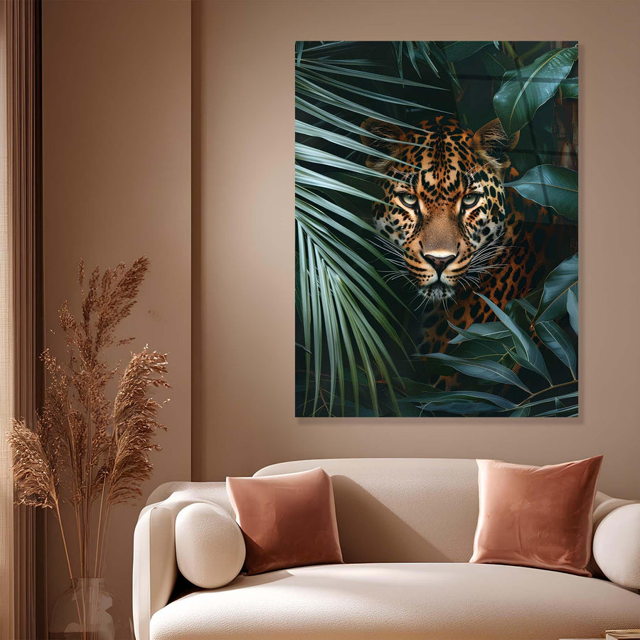 Framed artwork of a leopard among leaves on a wall above a sofa with pink cushions.
