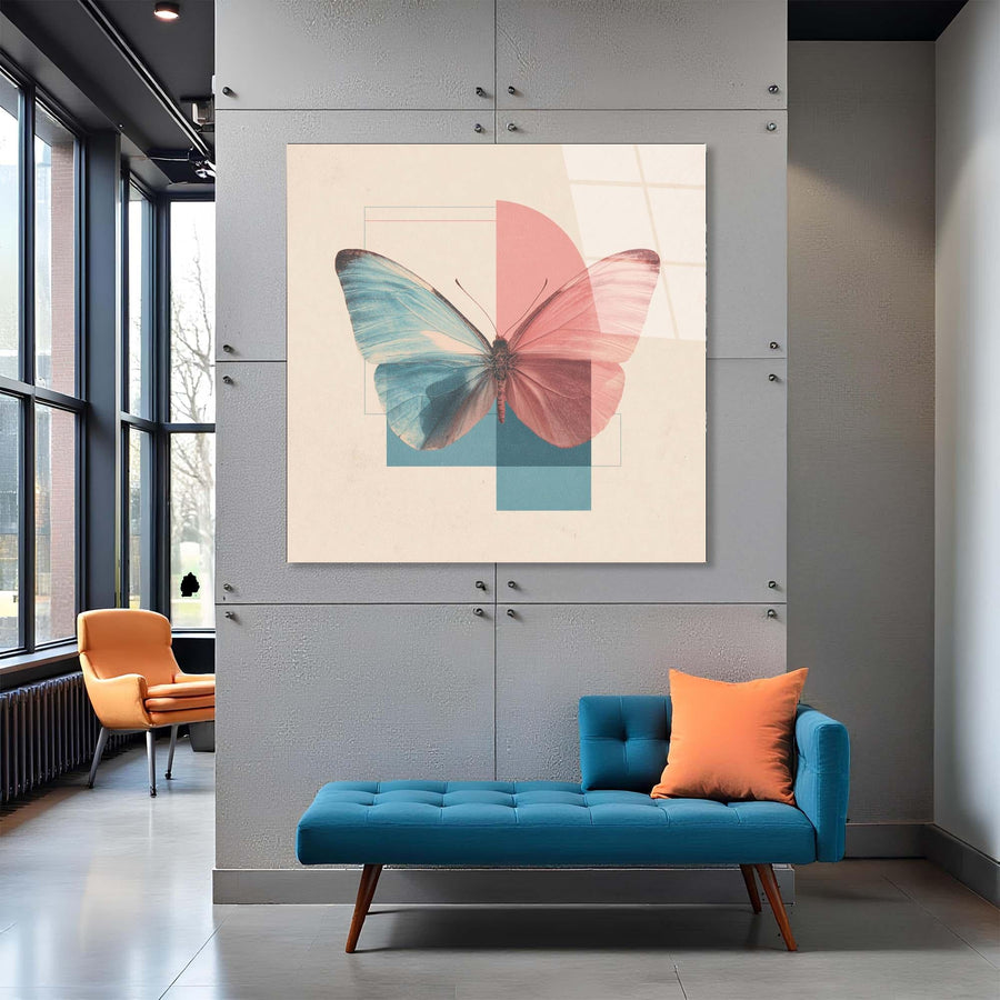 Modern interior with a blue sofa, orange chair, and colorful butterfly artwork on a gray wall.