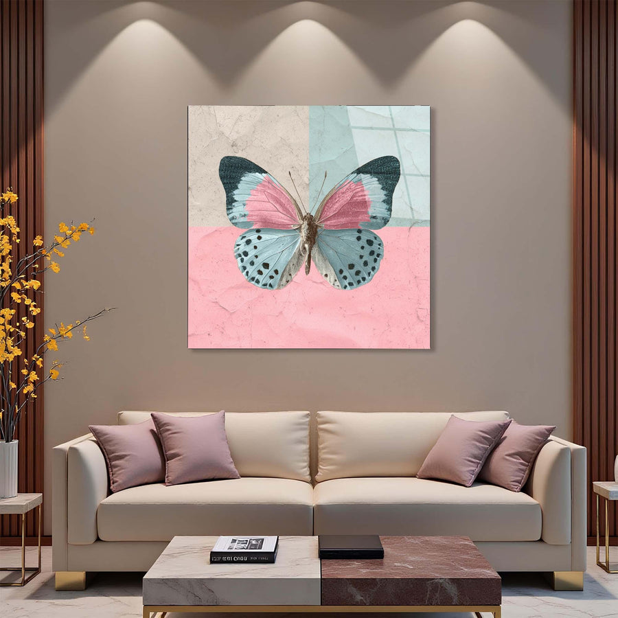 Butterfly artwork on a wall above a beige sofa in a living room setting.