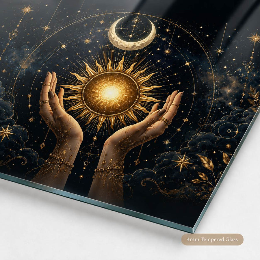 Tempered glass wall art featuring a mystical celestial design with a glowing sun, crescent moon, stars, clouds, and two raised hands, shown at an angle on a light background with a '4mm Tempered Glass' label.