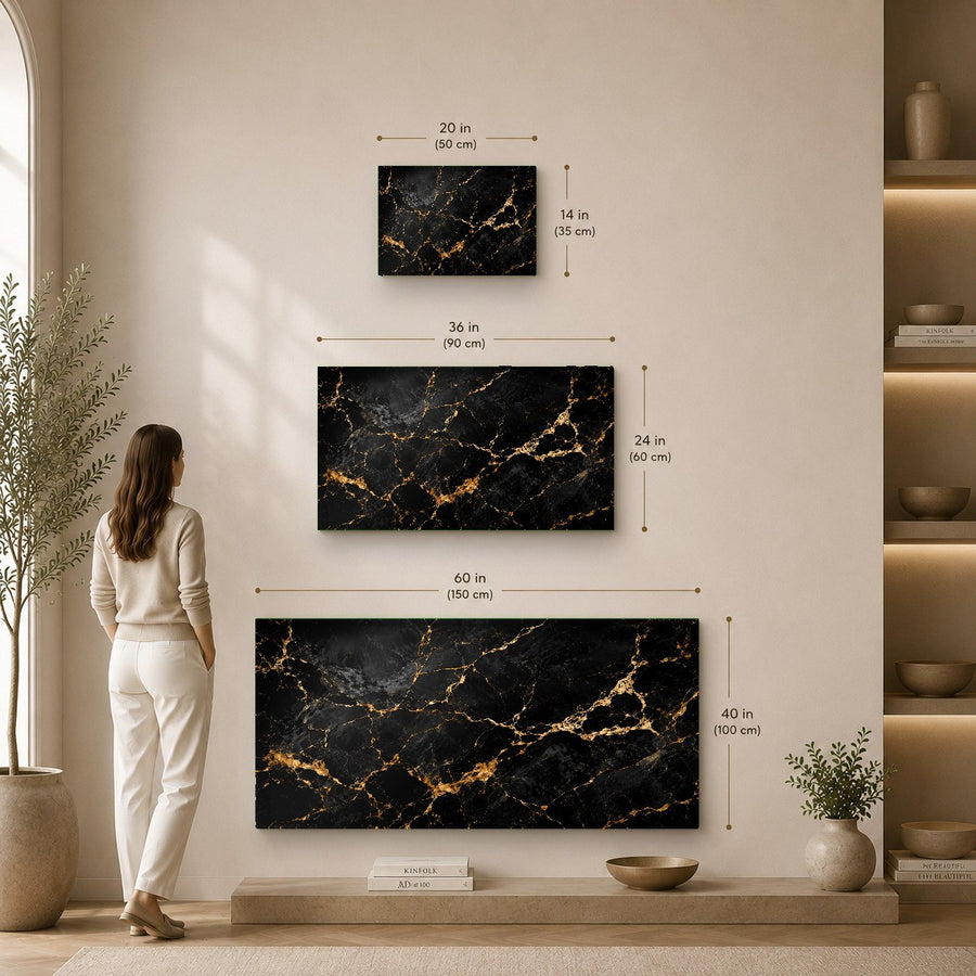 Stunning black and gold abstract glass print on a textured concrete wall in a chic hotel lobby.