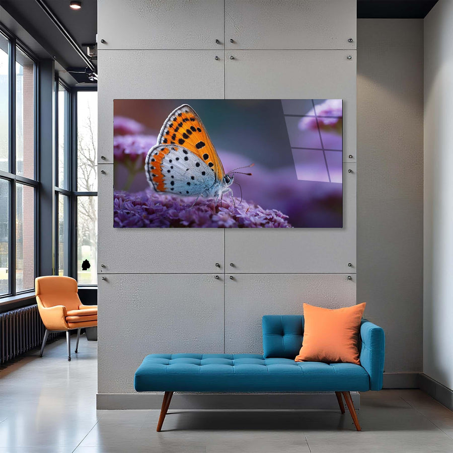Modern interior with a blue sofa, orange chair, and a large screen displaying a butterfly on flowers.