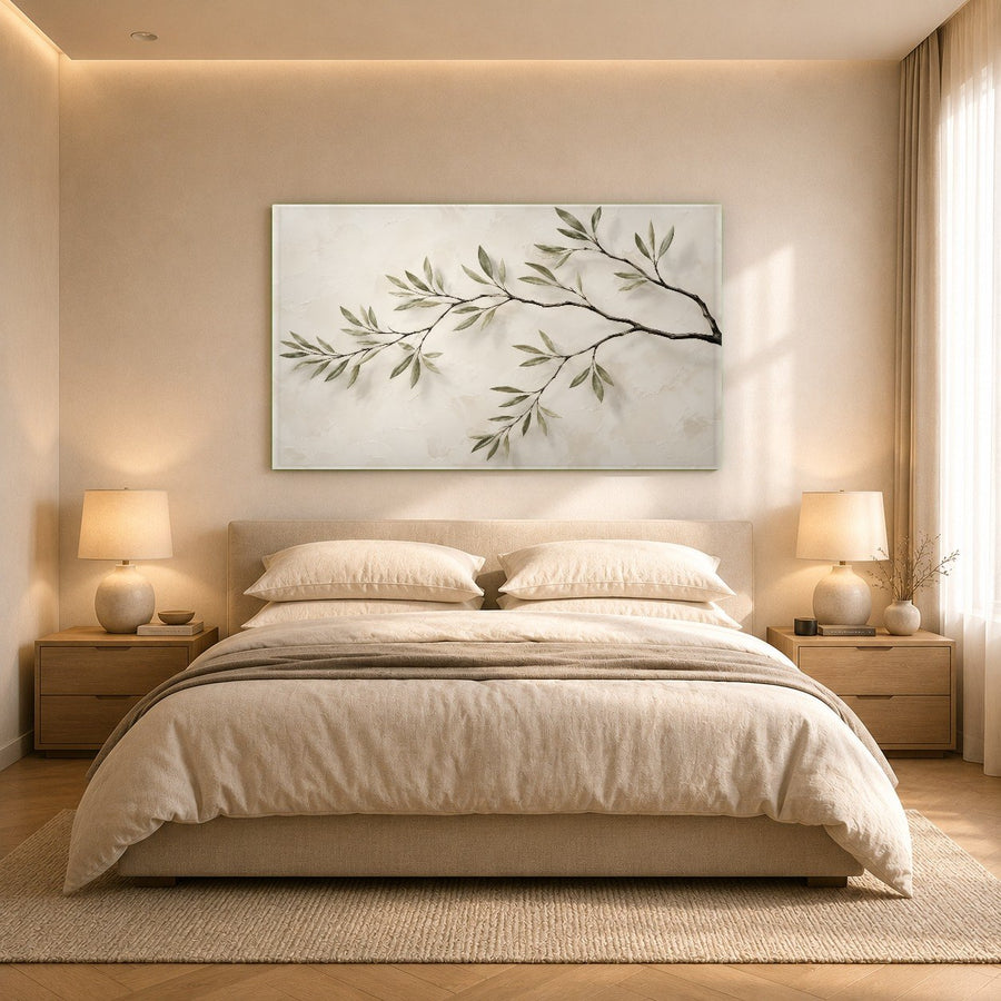 Tropical green leaves glass wall art hanging above a white freestanding bathtub in a luxurious, spa-like bathroom.