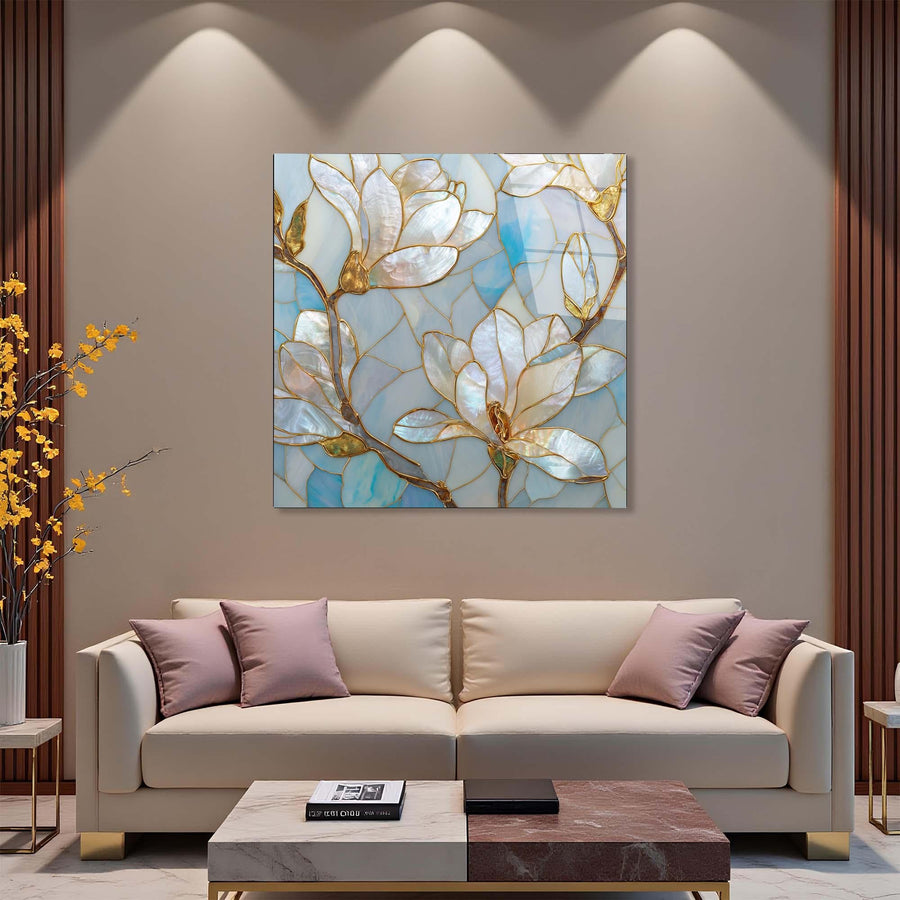 Decorative painting of floral design on a wall above a beige sofa with purple cushions.