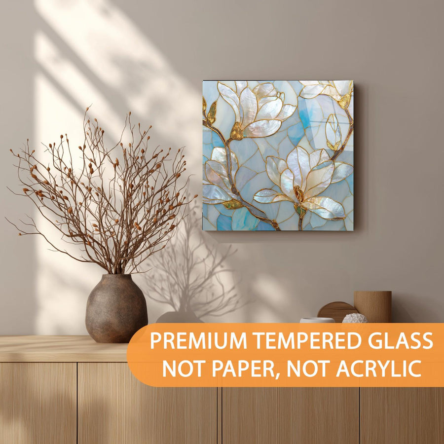 Decorative wall art with floral design on a wall above a wooden shelf.