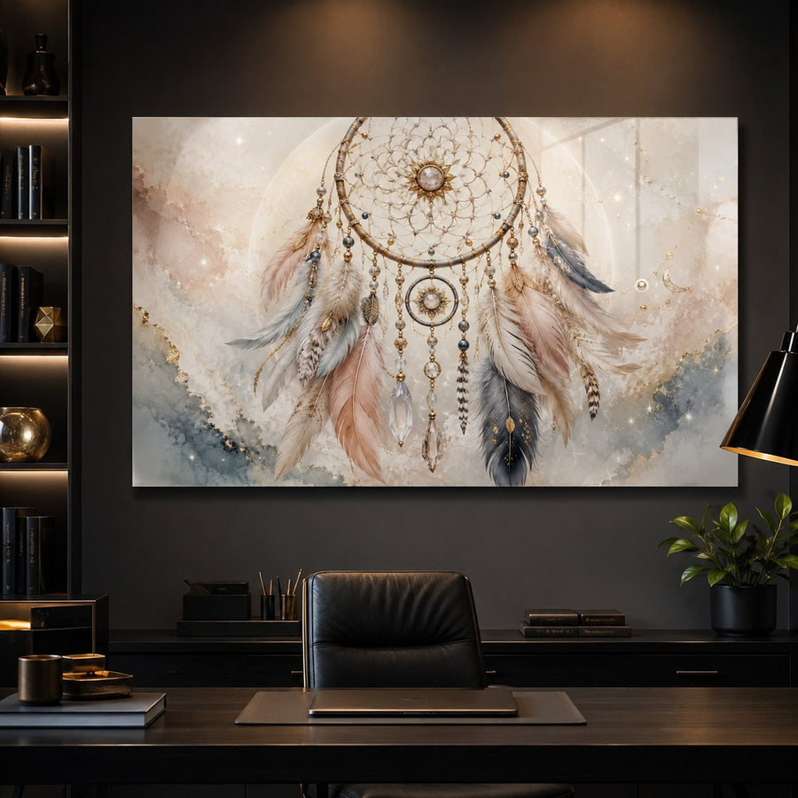 A large rectangular wall art print featuring a dreamcatcher with feathers and beads in soft neutral tones, displayed above a dark desk in a modern home office setting.